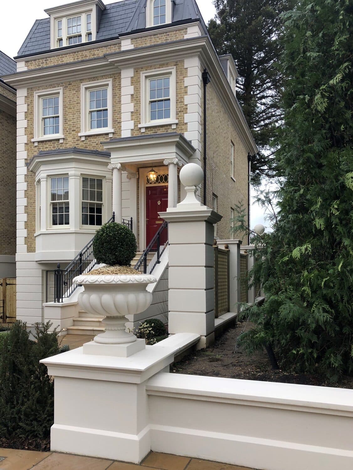 Front elevation of the Windsor private residential development with full-height quoin stones, cornice, window surrounds and a columned entrance portico.